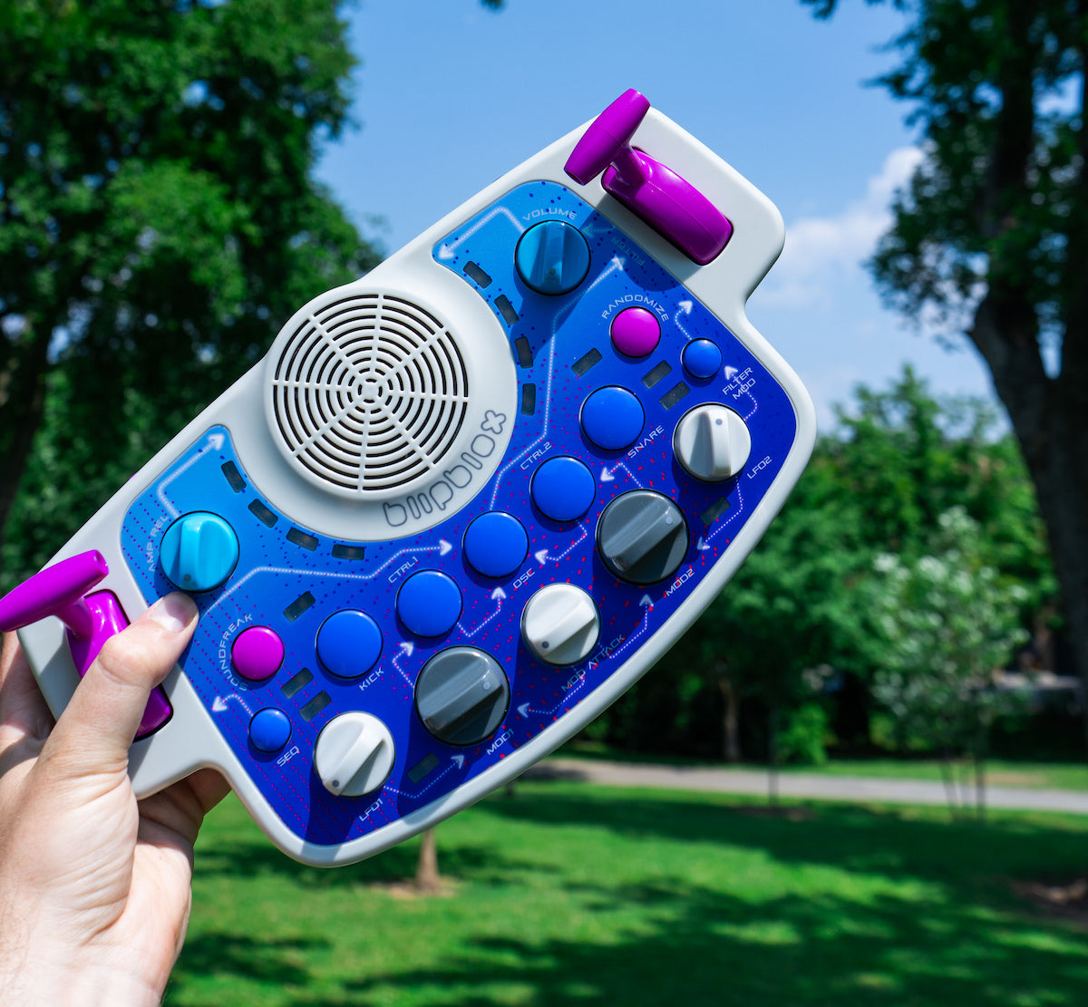 Blipblox SK2 held by a hand with a park in the background