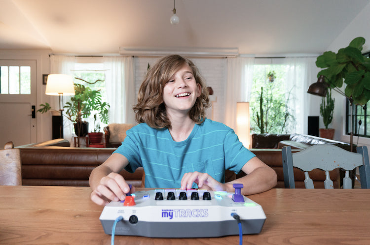 Child playing with a Blipblox myTRACKS at a living room table
