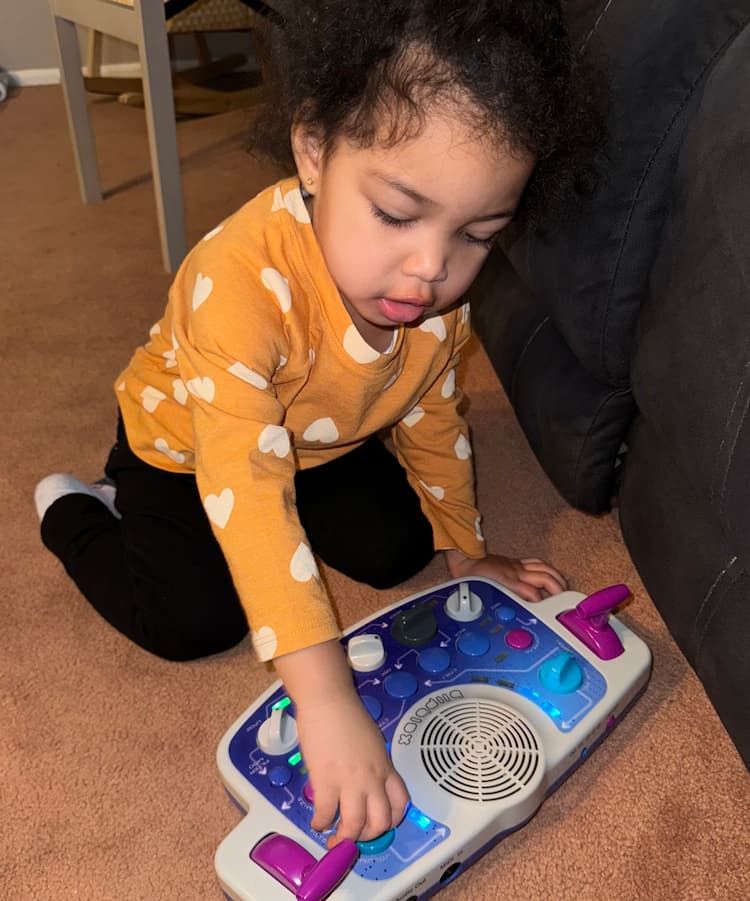 Child playing with a Blipblox SK2 on the floor