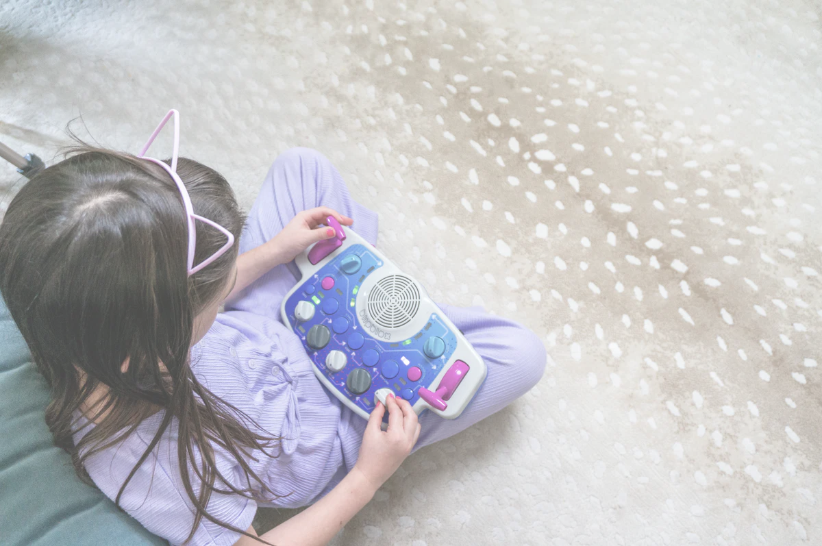 Child playing with a Blipblox SK2 on the floor
