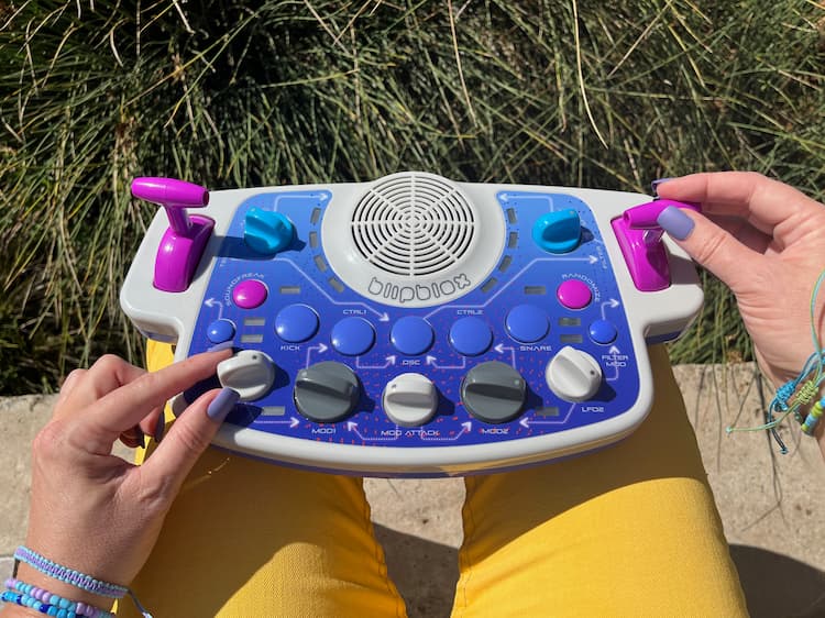 Person holding a Blipblox SK2 and playing  it in their lap outdoors